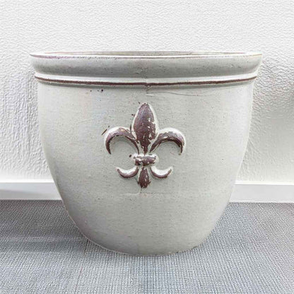 Round ceramic planter featuring elegant fleur-de-lis embossing in matte white finish