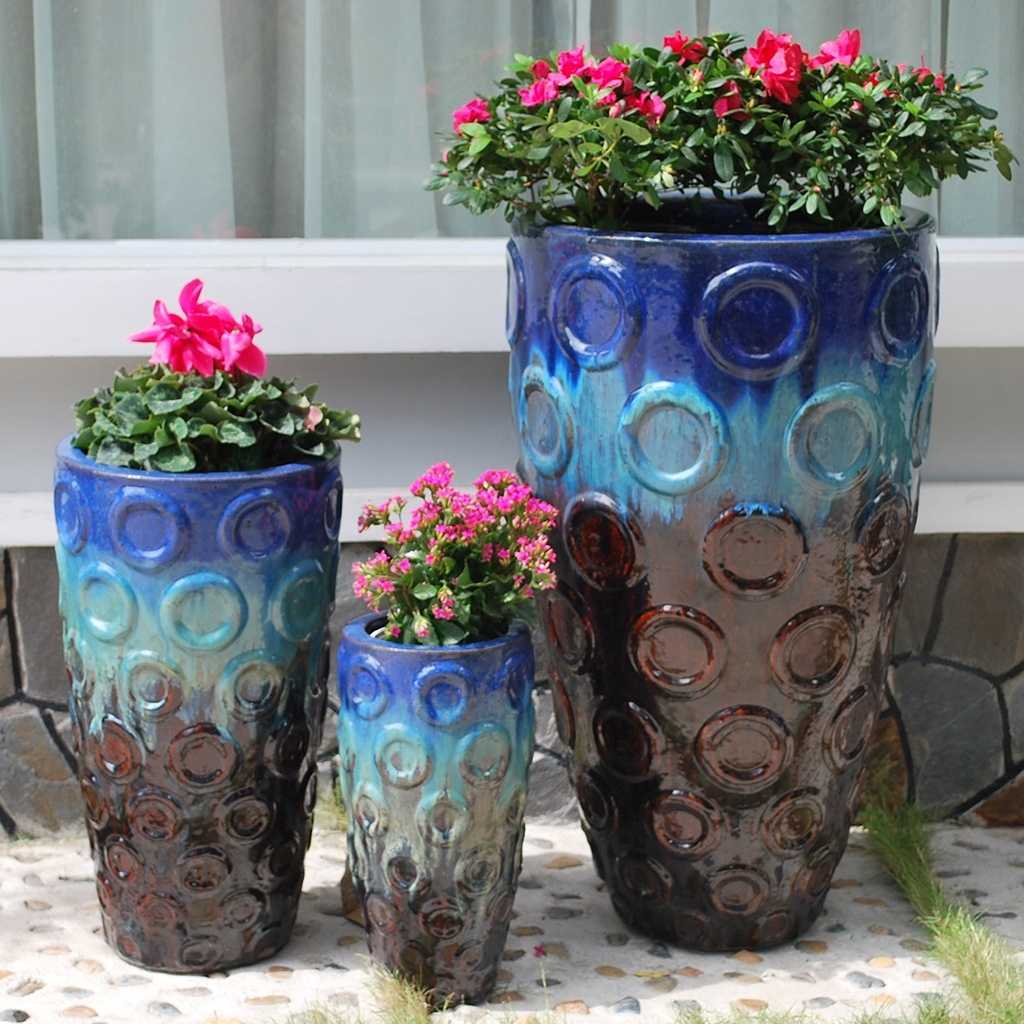 Tri-color tall tapered planters in brown, turquoise, and blue, featuring an embossed circular pattern