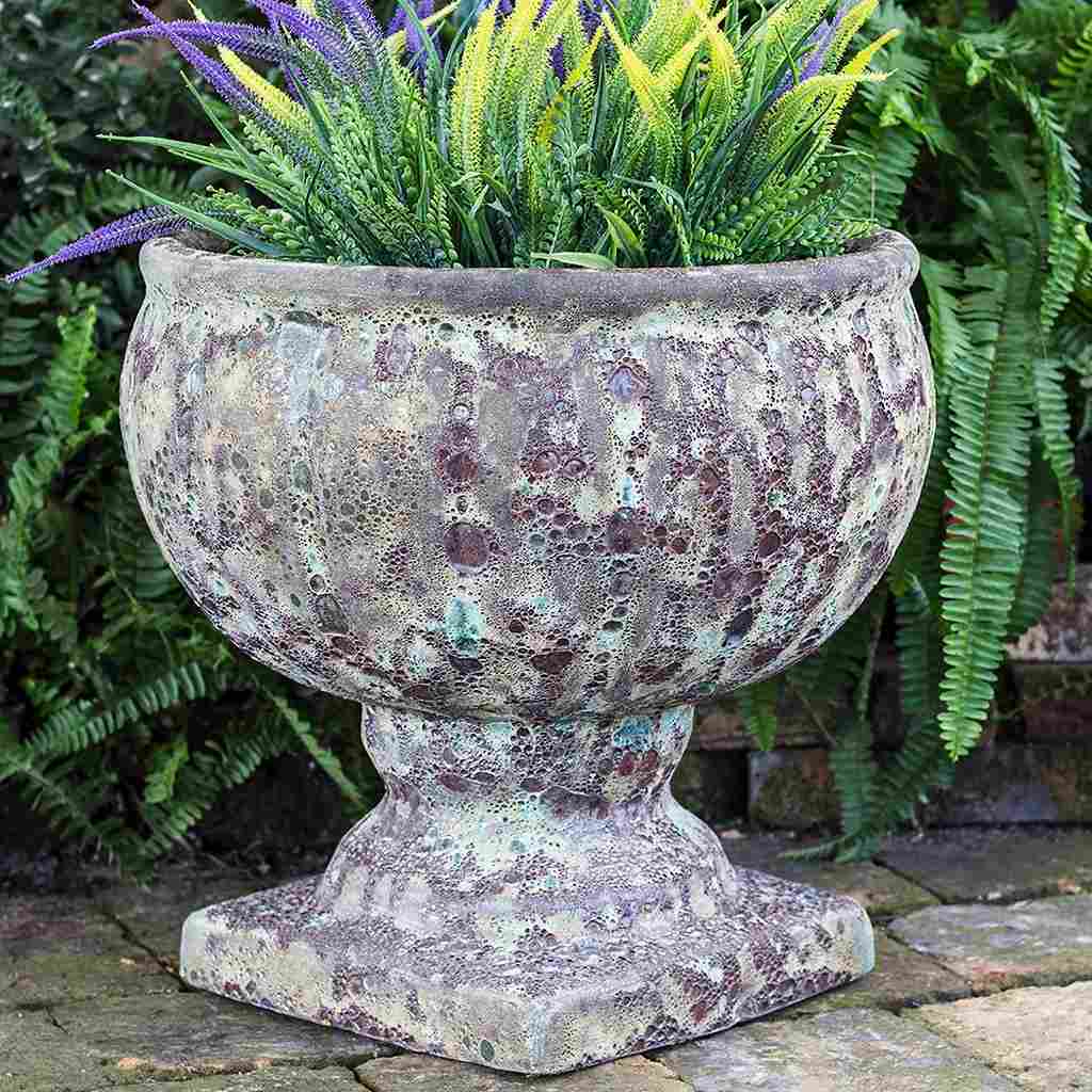 Round pedestal pot in a weathered Ocean Rock finish, evoking a natural, coastal-inspired look