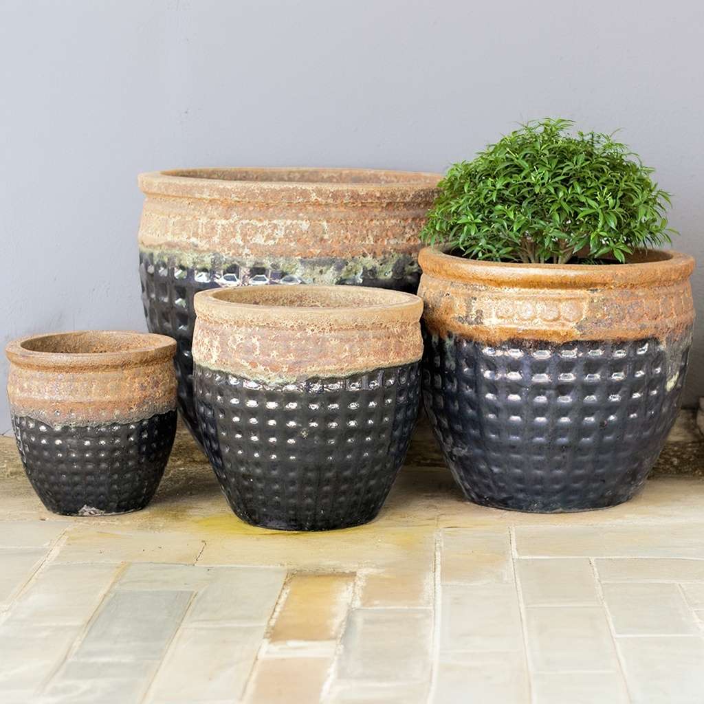 Two-tone waffle-pattern pot in black with a reddish-brown drip glaze effect