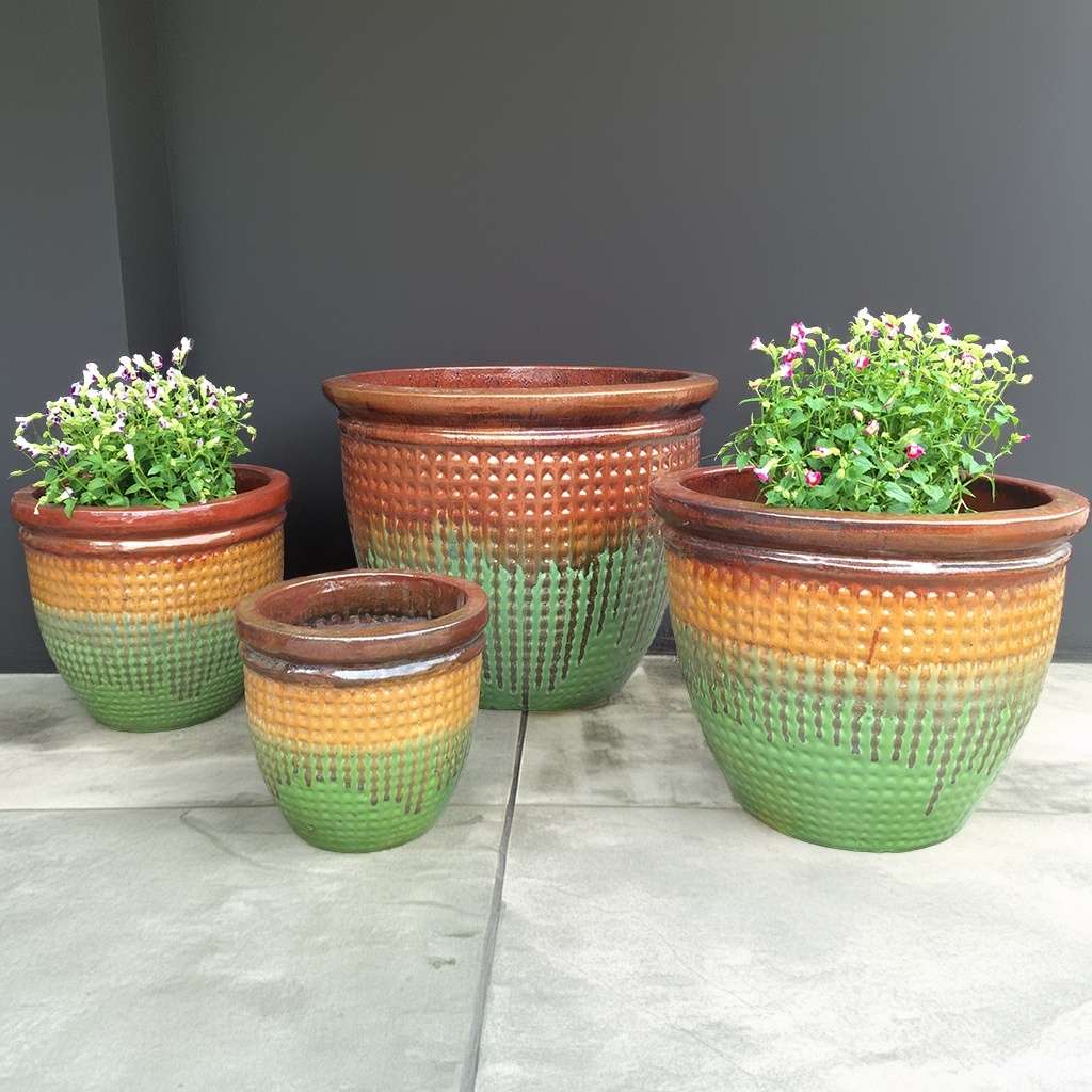 Textured dimpled planters with a gradient glaze of brown, orange and green
