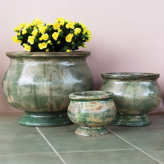 Wholesale set of rounded pedestal planter in glazed mottled green with a soft watercolor effect, showcasing smooth curves and a gently blended finish
