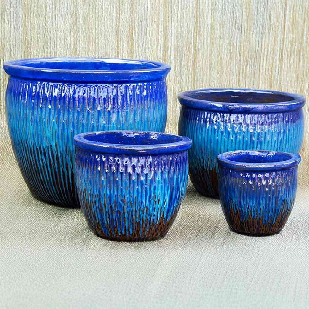 Wholesale Ribbed ceramic pot with a glossy blue finish and a brown accent base