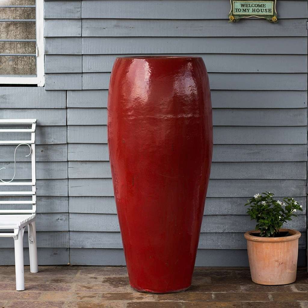 Tall, tapered ceramic garden pot with a glossy red finish