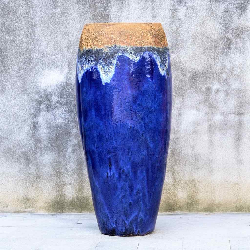 Tall tapered ceramic garden pot in vibrant blue glaze with an unglazed, textured reddish-brown rim