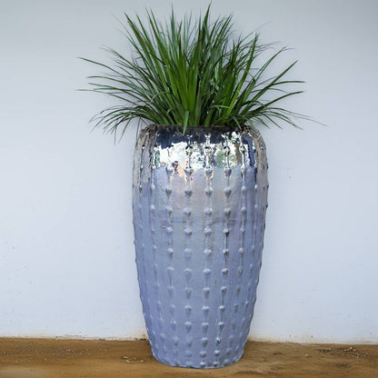 Tall ribbed ceramic planter with a glossy gray finish