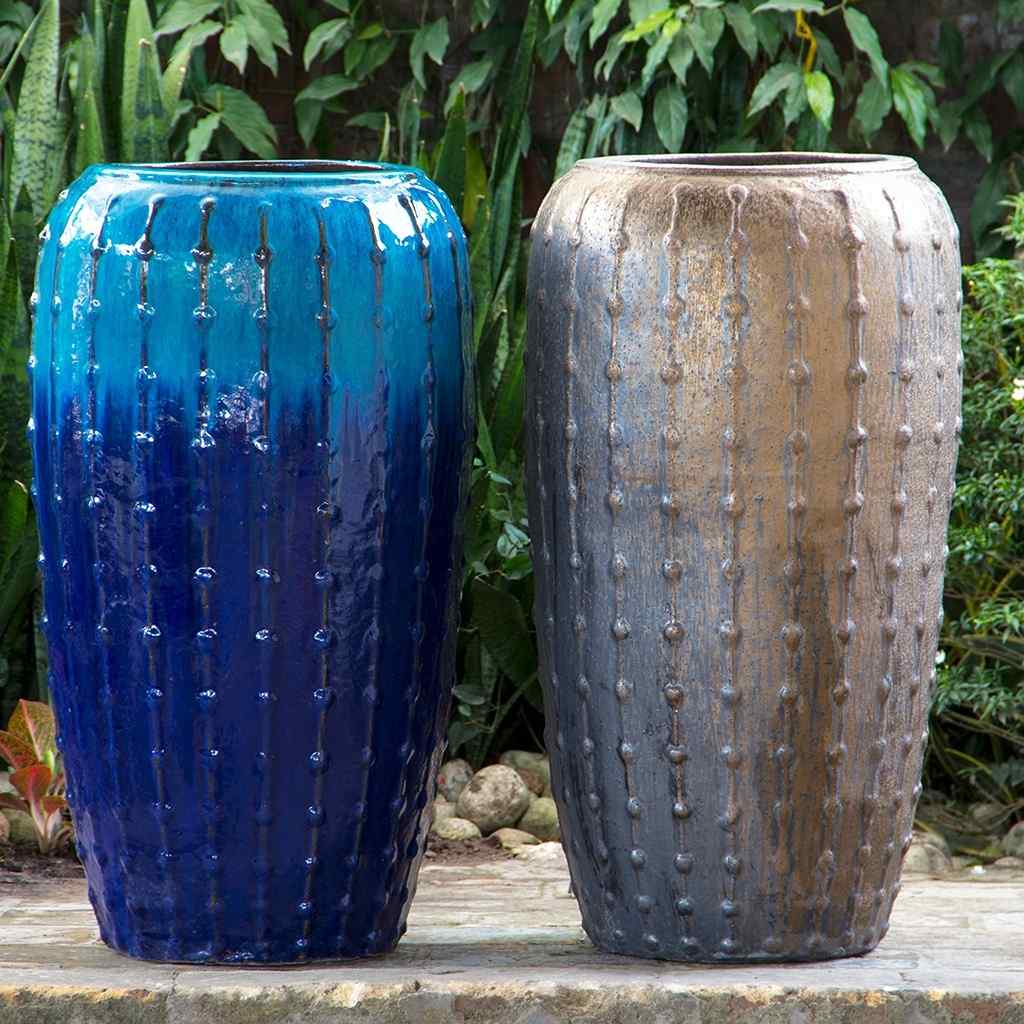 Tall ribbed ceramic planter with a glossy blue body and metallic gray accents
