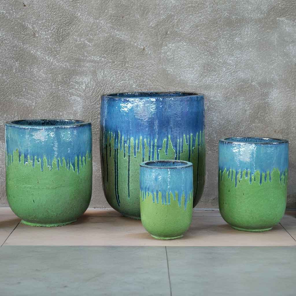 Tall rounded cylinder ceramic planters in glossy green glaze with distinctive blue drip accents