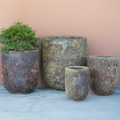 Tall rounded cylinder planters with bubbled glaze in brown, gray, and green shades, accented by reddish and yellowish tones for a natural patina effect