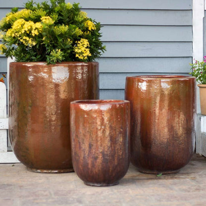 Tall, rounded cylinder planters in volcanic red with a smooth finish