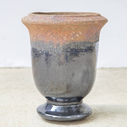 Two-tone pedestal ceramic planter featuring a glazed silver gray body and a textured, unglazed brown rim