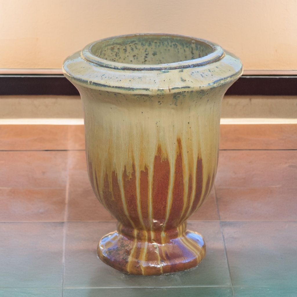 Two-tone pedestal ceramic planter featuring a drip glaze in beige and brown tones
