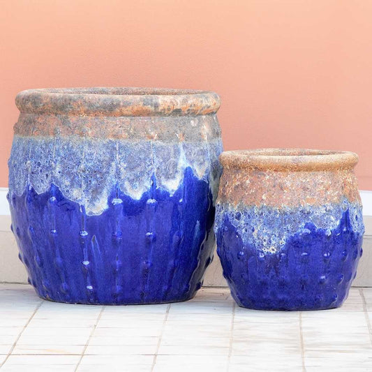 Bulk Rounded blue ceramic planters with a rustic top, textured dripping glaze, and vertical dotted ridges