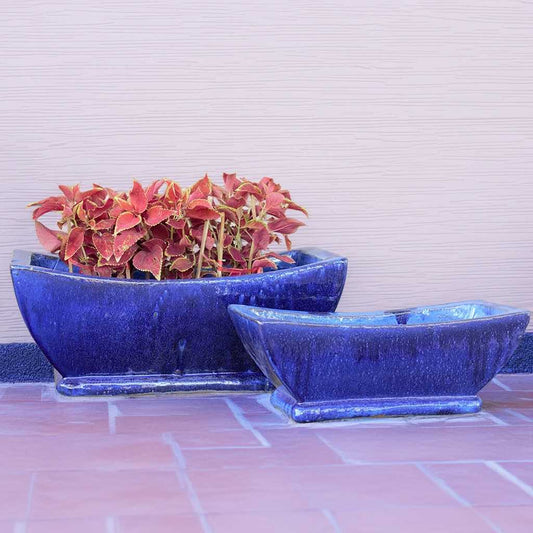 Wholesale Canoe-shaped ceramic planters with a smooth glazed blue finish and sleek, elongated design