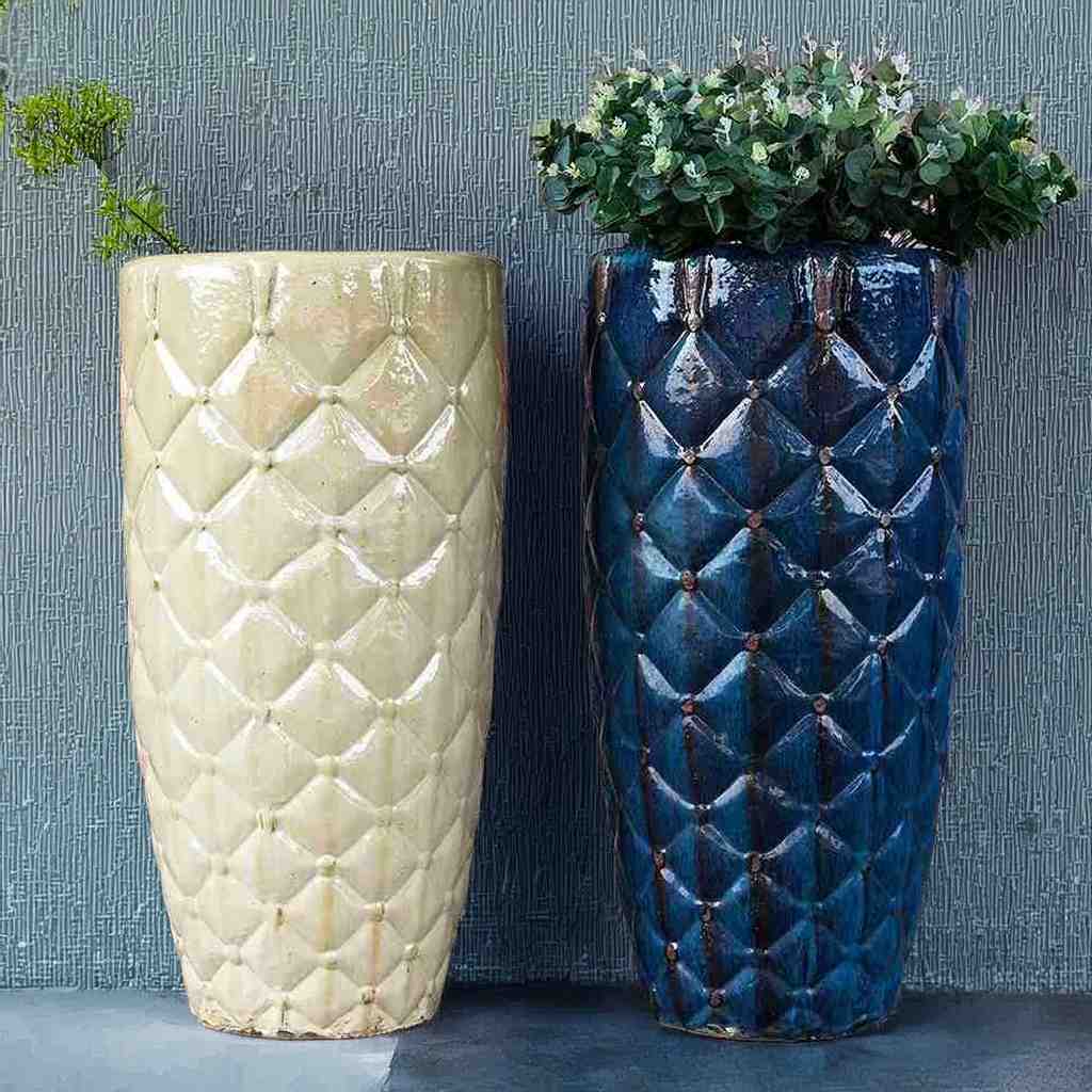 Quilted tall ceramic planters in antique cream and dark blue with a textured, diamond-patterned surface