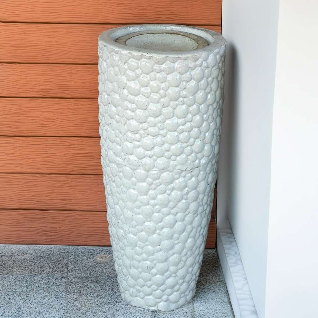 Tall ceramic planter with a pebbled texture in glossy white