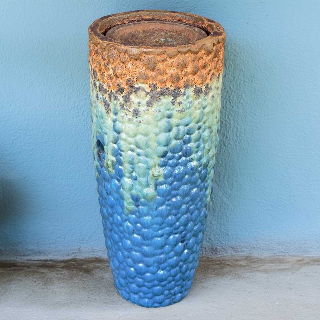 Tall ceramic planter with a pebbled texture in aqua blue with turquoise and rustic texture top