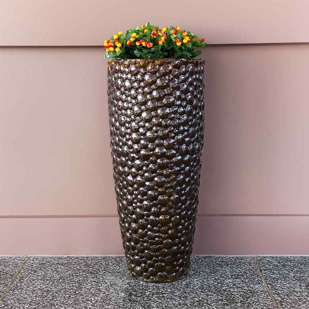 Tall ceramic planter with a pebbled texture in glossy dark brown