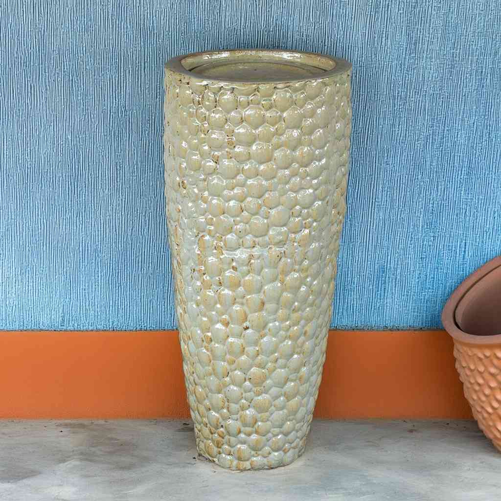 Tall ceramic planter with a pebbled texture in antique cream
