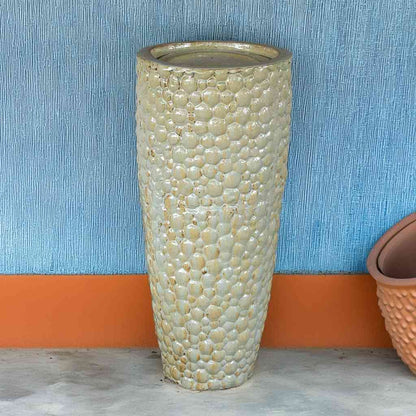 Tall ceramic planter with a pebbled texture in antique cream