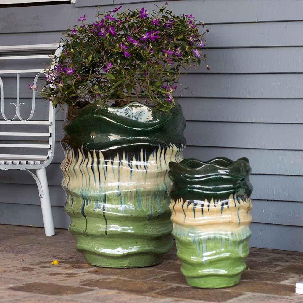 Multi-toned wave rim ceramic planter featuring shades of green and cream