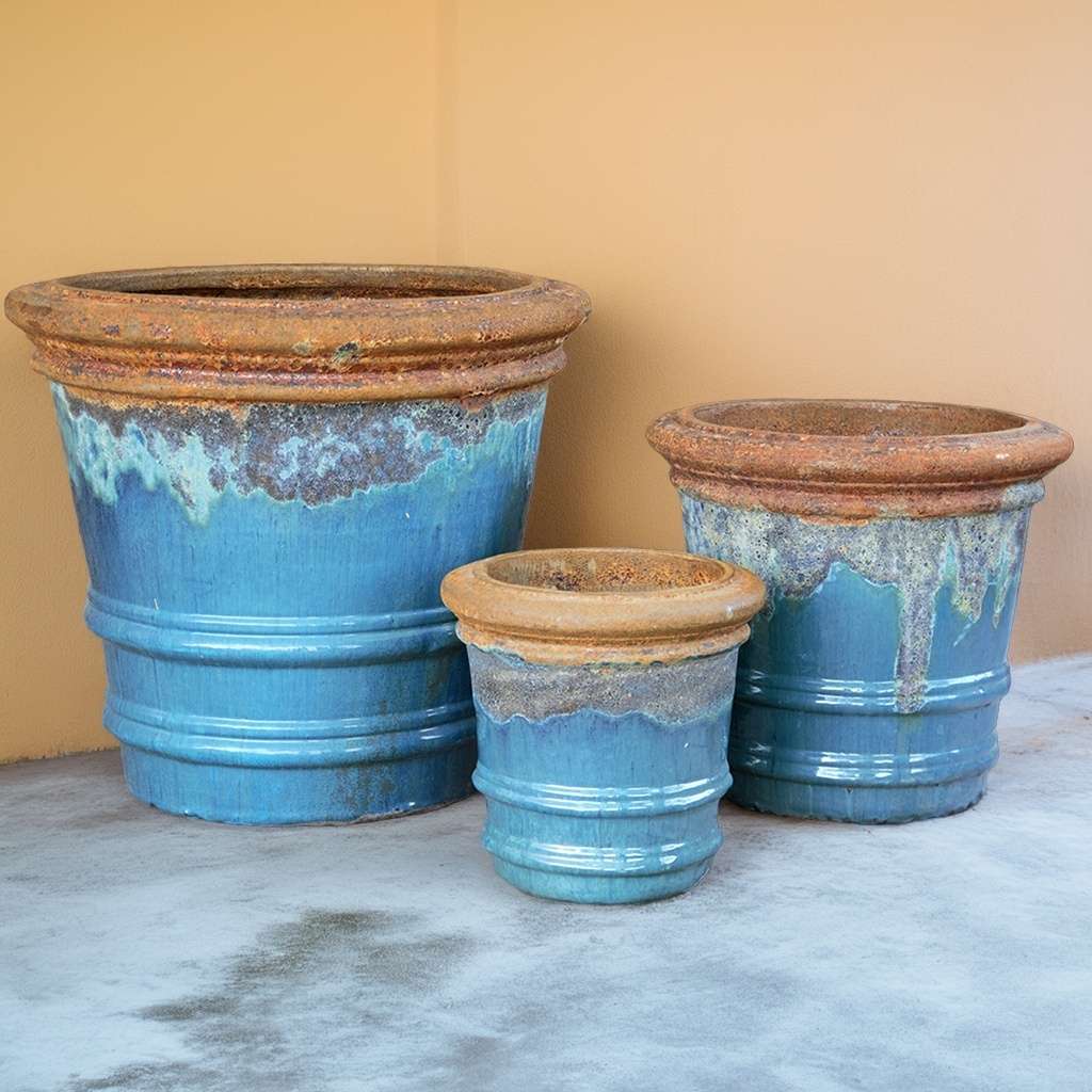 Ceramic planters with a blue glazed finish and a frosted rim