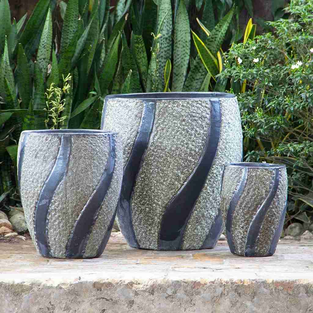 Modern oval ceramic pot with a textured white stone finish and gray swirling accents