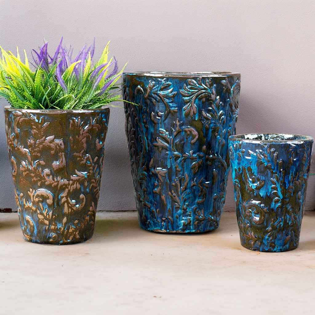 Elegant tall tapered planter in blue with brown accents, featuring an embossed foliage pattern