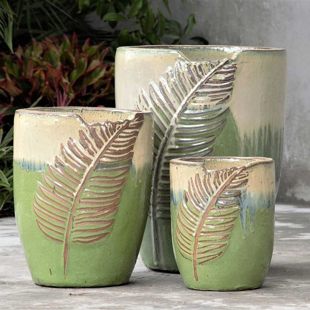 Wholesale Leaf-embossed oval ceramic planter in apple green with a smooth cream-colored top rim