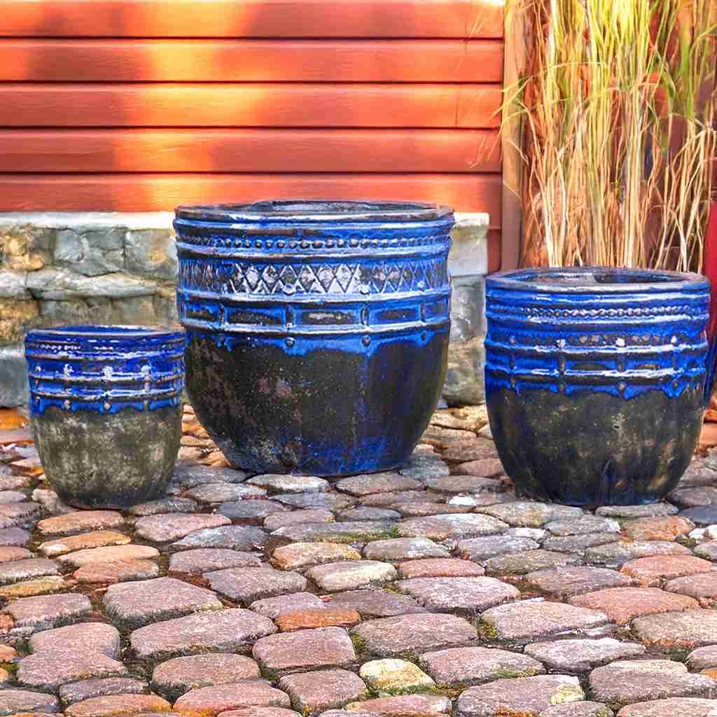 Elegant rounded ceramic planter with a cobalt blue glazed finish and intricate textured detailing