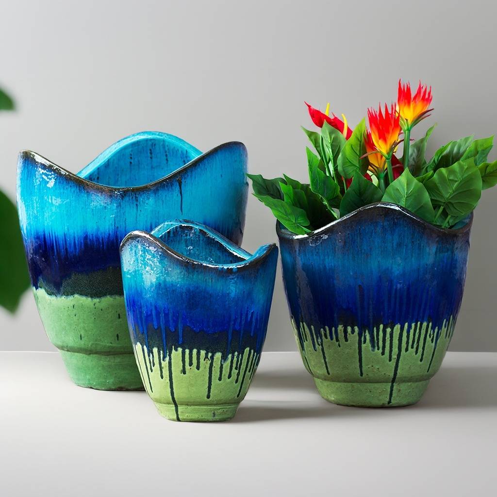 Wholesale Wave-top ceramic planter in green and blue with a dripping glaze effect, featuring a sculpted rim and artistic, fluid color transitions