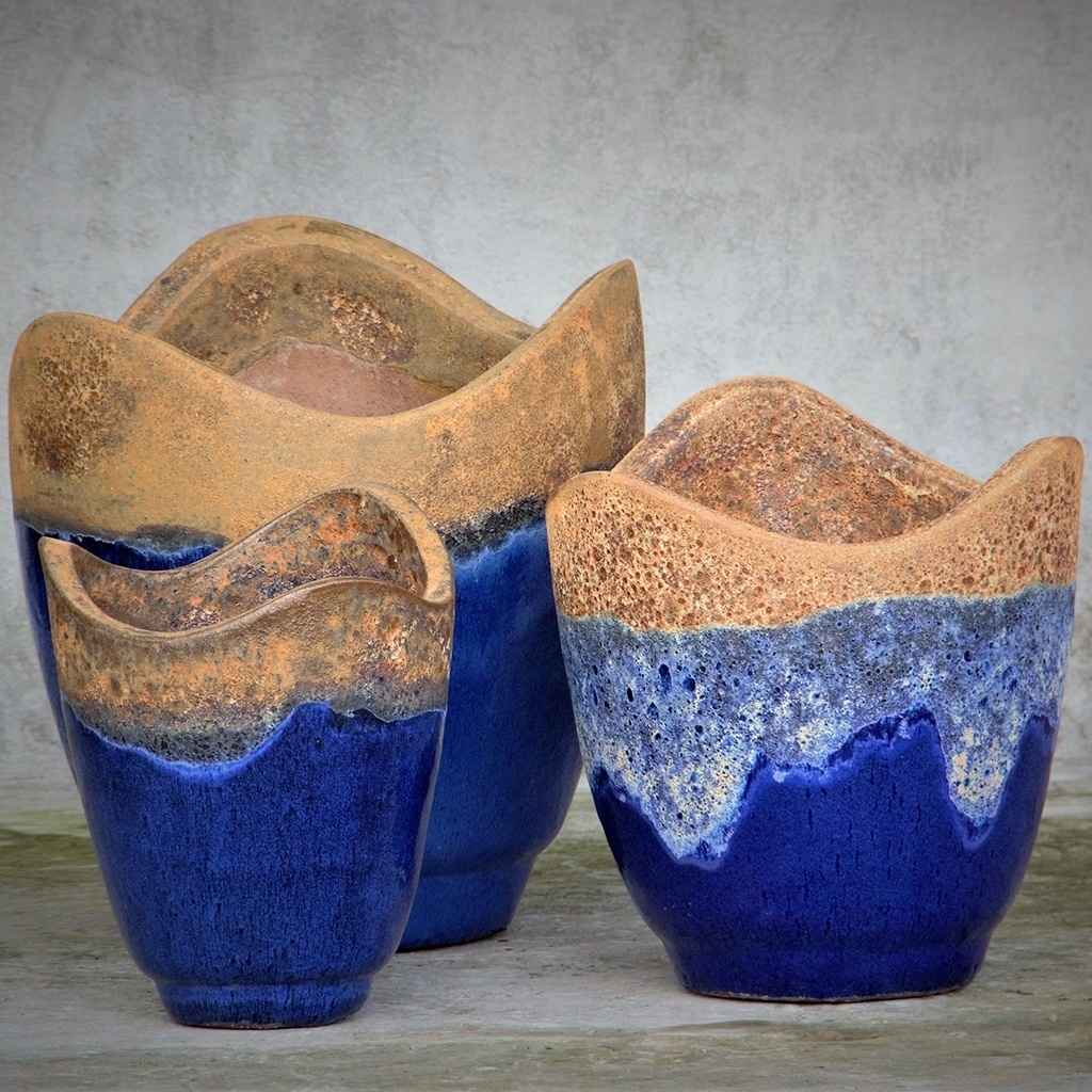 Wave-top ceramic planter in dark blue with a rustic, textured rim