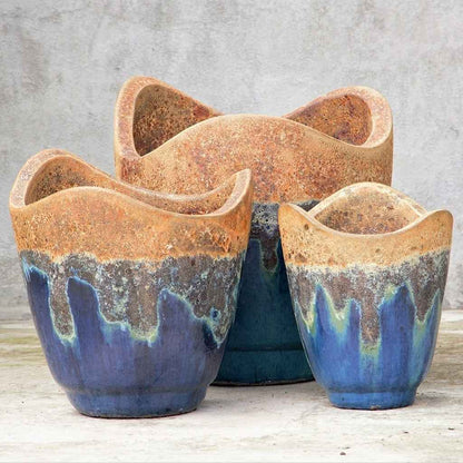 Wave-top ceramic planter in blue with a rustic, textured upper rim