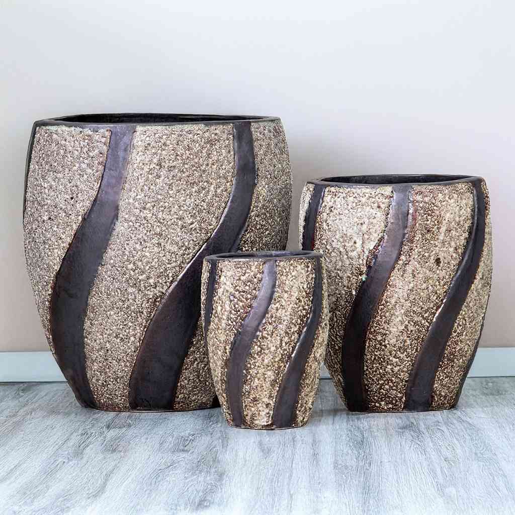 Modern oval ceramic pot with a textured white stone finish and dark brown swirling accents