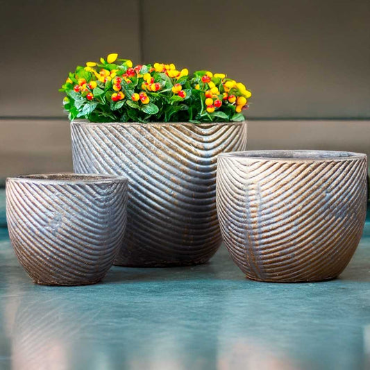 Wholesale Ridged round planter featuring a textured brown surface accented with turquoise tones