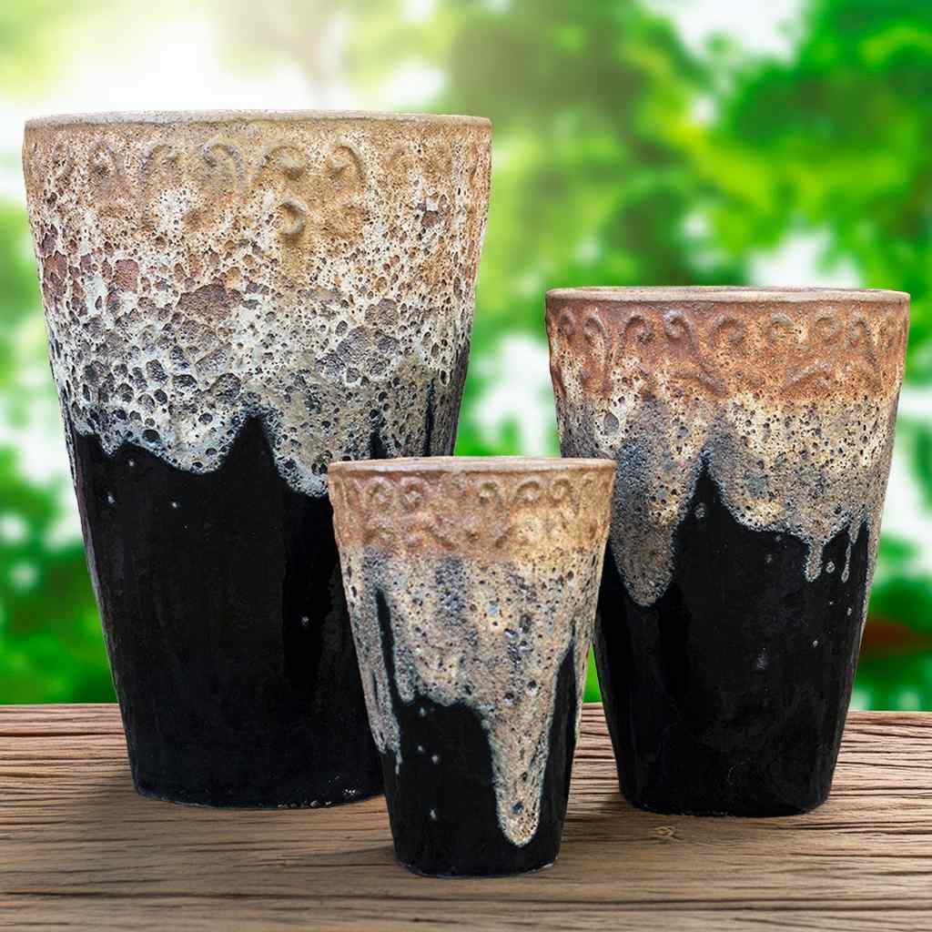 Tall ceramic planter in glossy black featuring a textured top with a subtle dripping glaze effect
