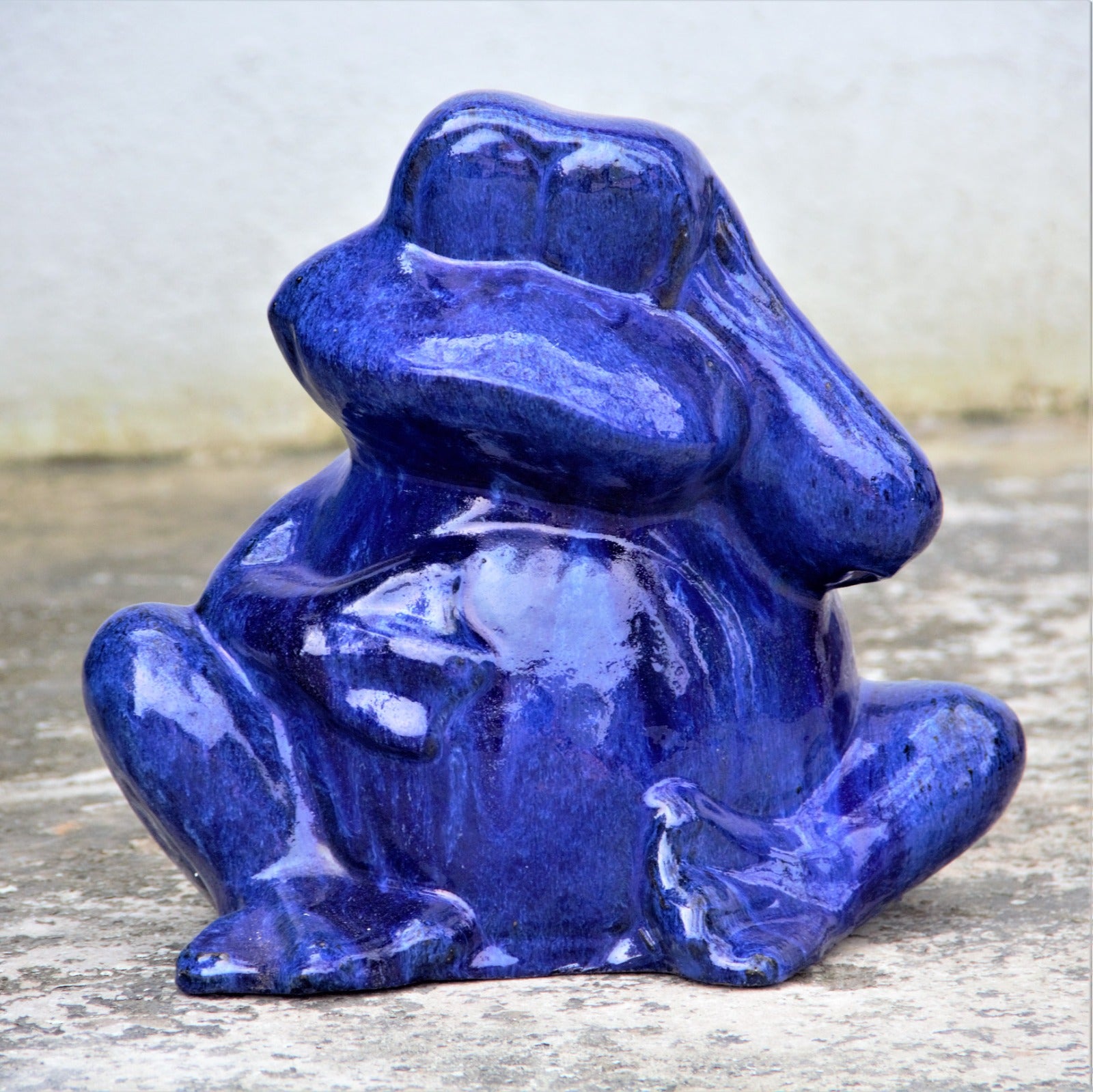 Blue ceramic frog garden decor