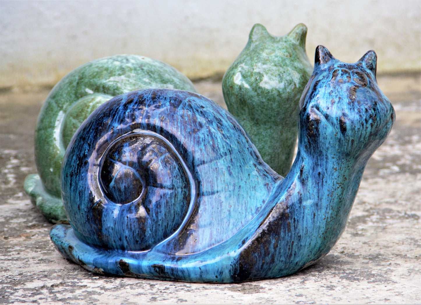 Glossy green and blue ceramic snails for garden