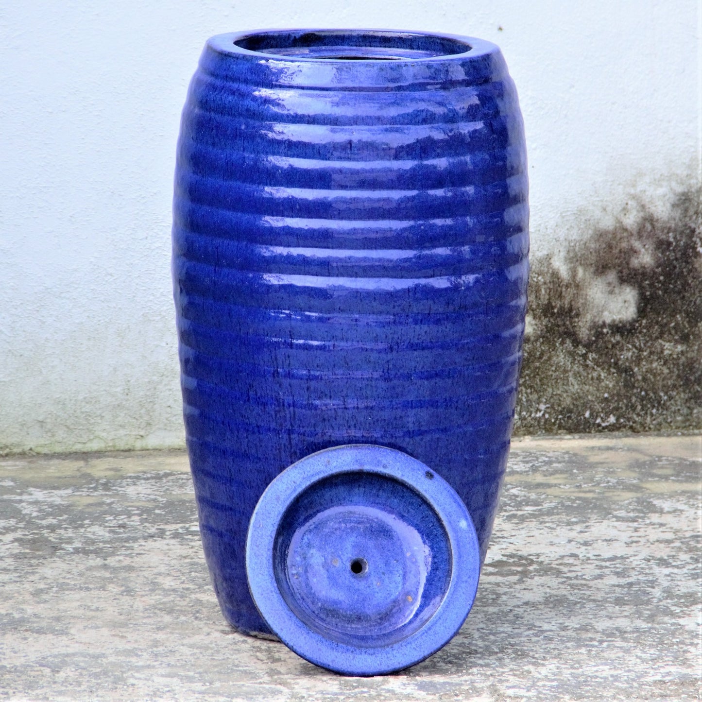 Glossy blue ribbed fountain jar