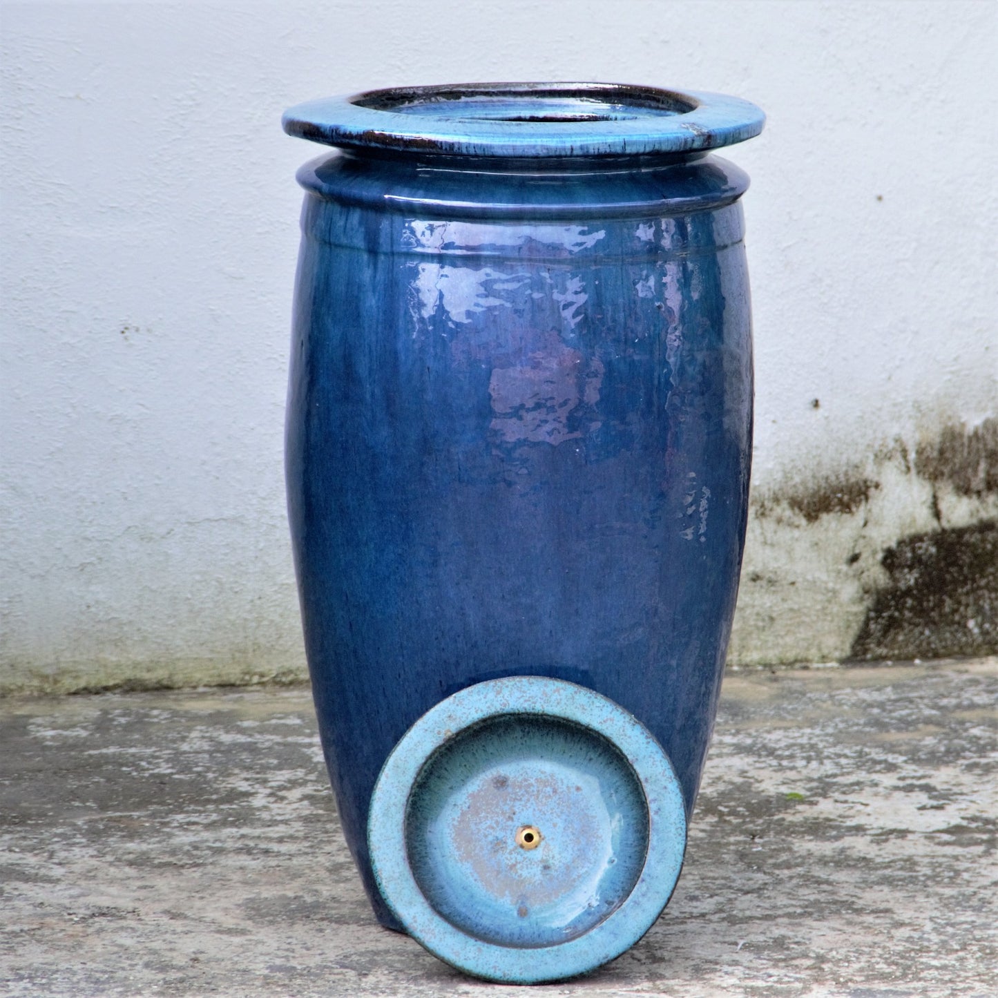 Glossy blue water jar fountain